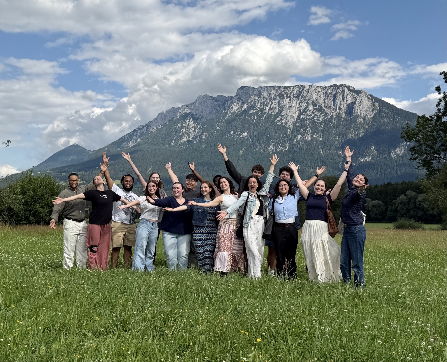 MTB students cheering in a meadow below the mountains