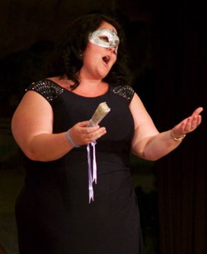 Masked soprano singing in performance