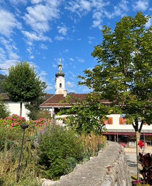 Oberaudorf church tower under blue sky